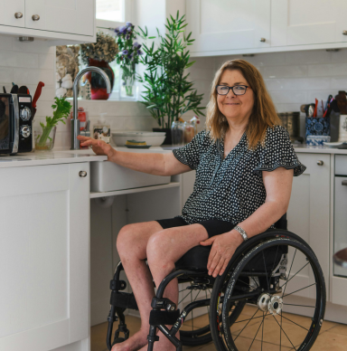 Person in a wheelchair in their accessible kitchen